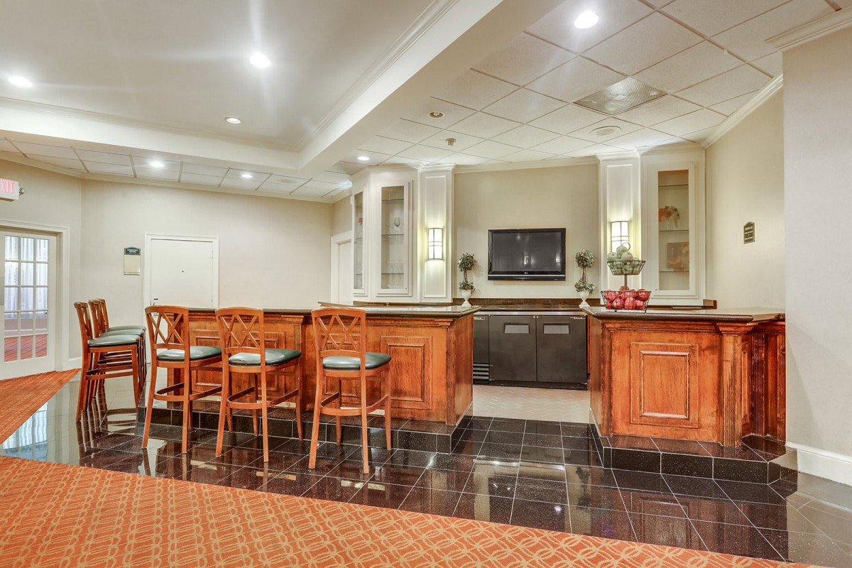 A modern bar area with seating and stylish lighting.