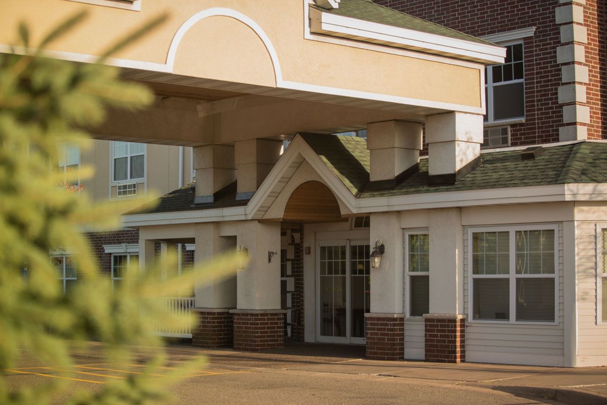 The entrance of a building with an archway and an awning.