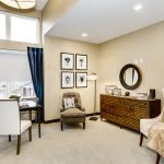 A stylish and modern living space featuring a home office setup with elegant furniture and decorative elements.