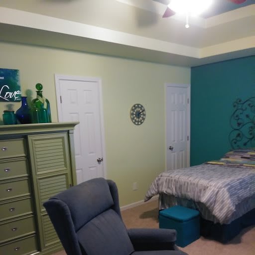 A cozy bedroom with colorful walls and stylish decor.