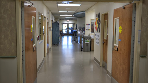 A view of a clean and well-lit hallway in a medical facility.