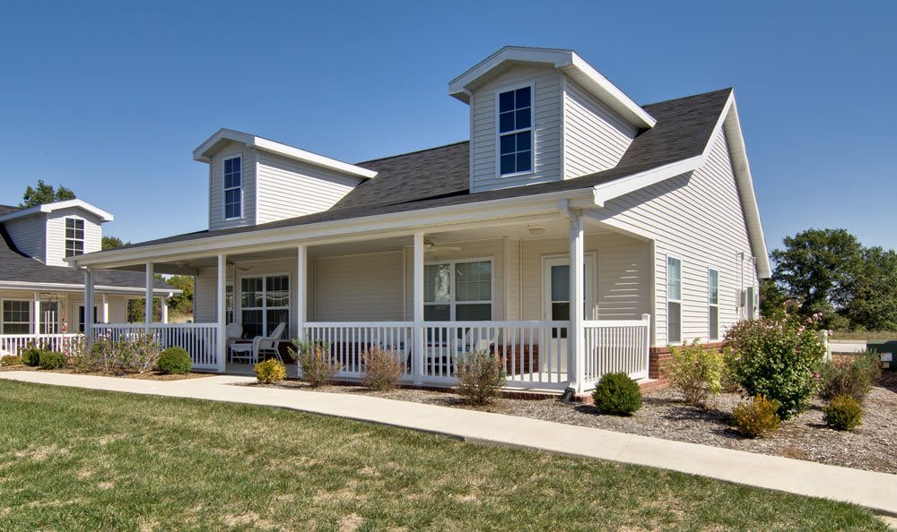 A charming single-family home with a front porch and well-maintained yard.
