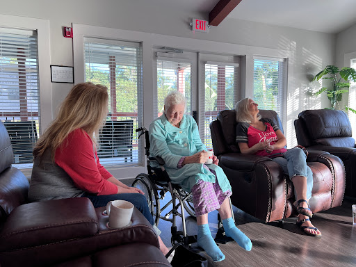 An intimate moment shared among three women in a cozy indoor setting, highlighting the importance of companionship and community.