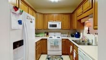 A cozy kitchen with wooden cabinets and modern appliances.