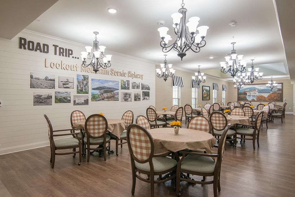 A beautifully decorated dining room with elegant chandeliers and neatly arranged tables and chairs.