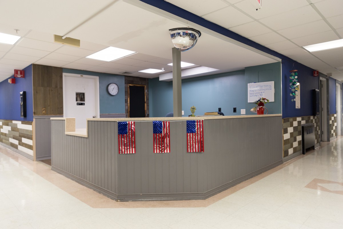 A reception area with a counter decorated with American flags.