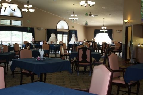 An elegant dining room with neatly arranged tables and chairs.