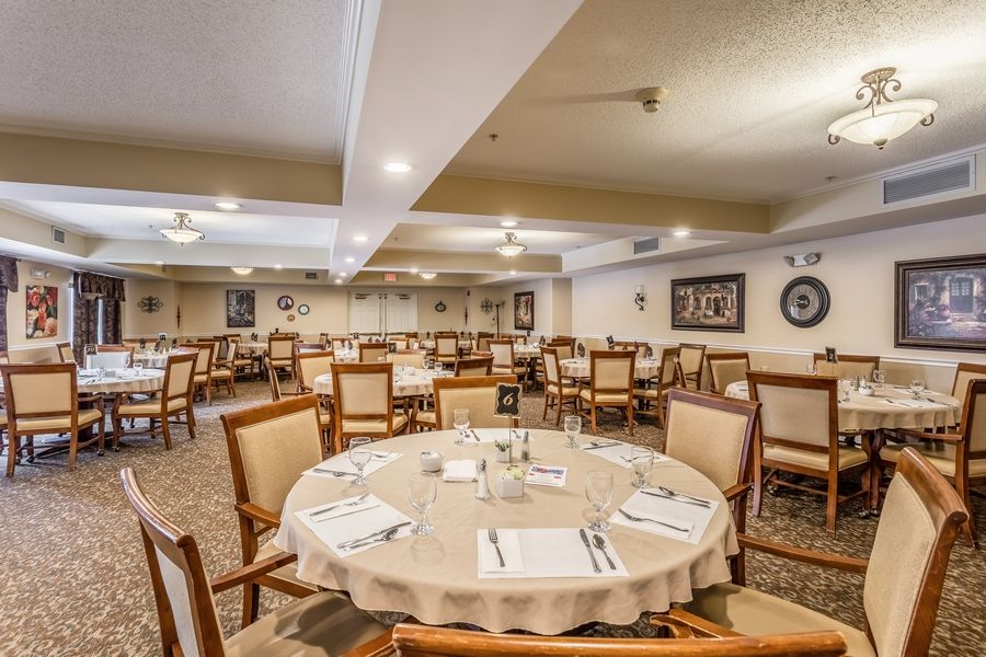 A well-decorated dining room with neatly arranged tables and chairs, ready for guests.