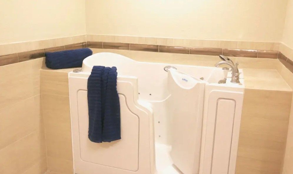 An accessible walk-in bathtub equipped with a towel, designed for ease of use.
