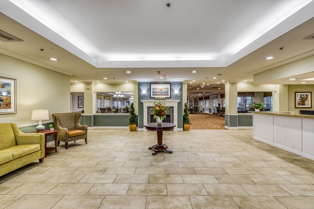 A spacious and elegantly decorated lobby with comfortable seating and a reception desk.