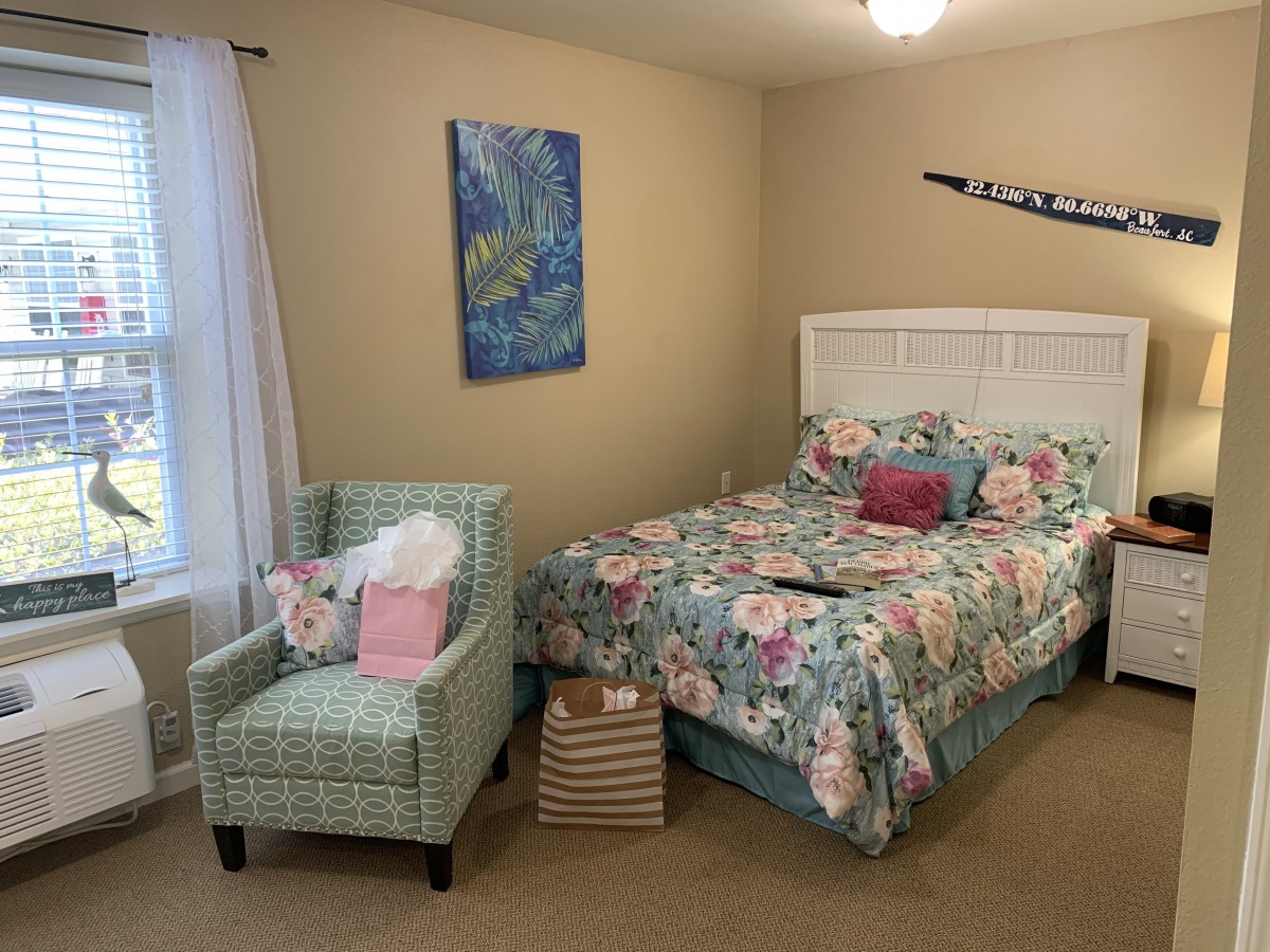 A cozy bedroom with floral bedding and stylish decor.