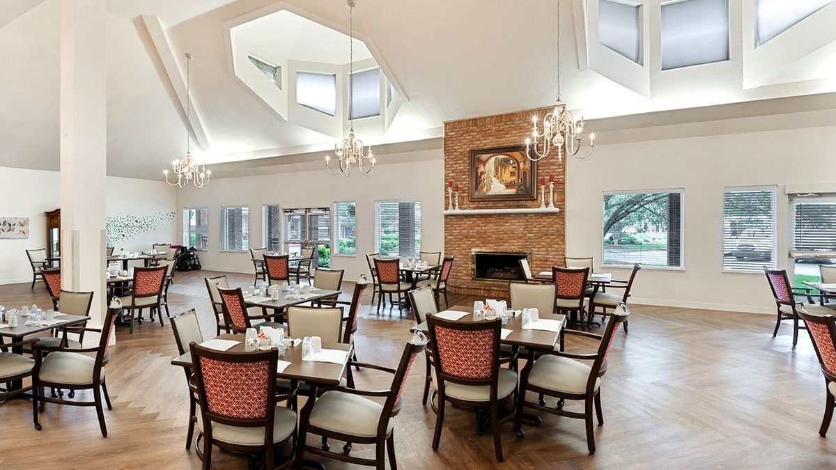 A spacious, elegant dining area with sophisticated lighting and a cozy fireplace.