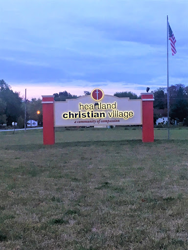 A sign for a Christian organization at dusk.
