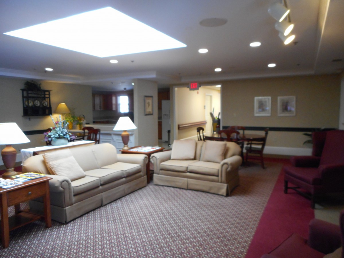 A cozy living room with sofas, a coffee table, and warm lighting.