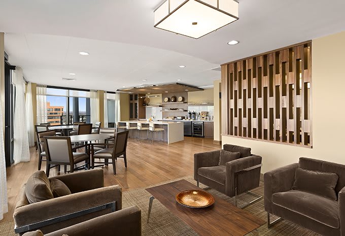 A spacious modern open-plan living and dining area with a sleek kitchen.