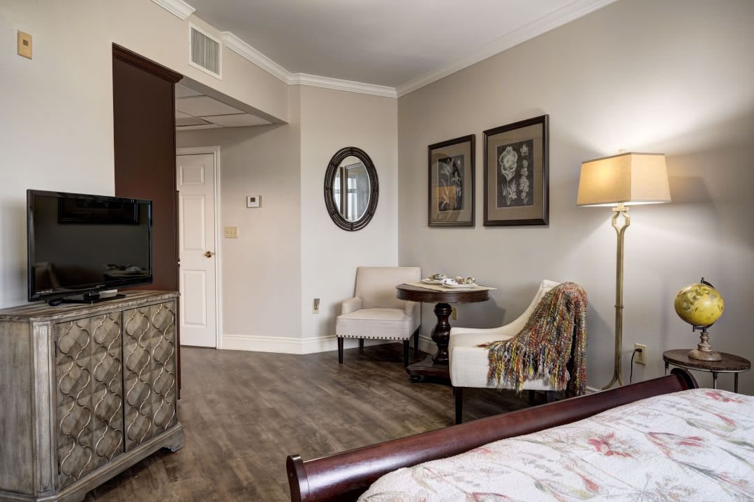 A cozy hotel room with elegant furniture and decor.
