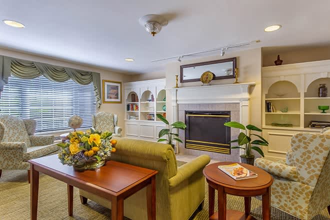 A cozy living room with a fireplace and comfortable seating arrangement.