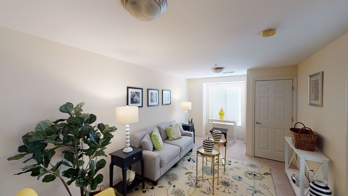 A cozy living room with modern decor, featuring a comfortable sofa, stylish coffee tables, and elegant lamps.