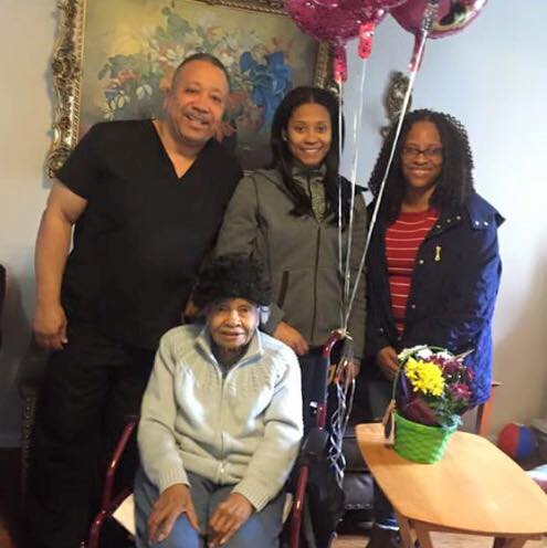 A joyful family gathering with balloons and smiles.