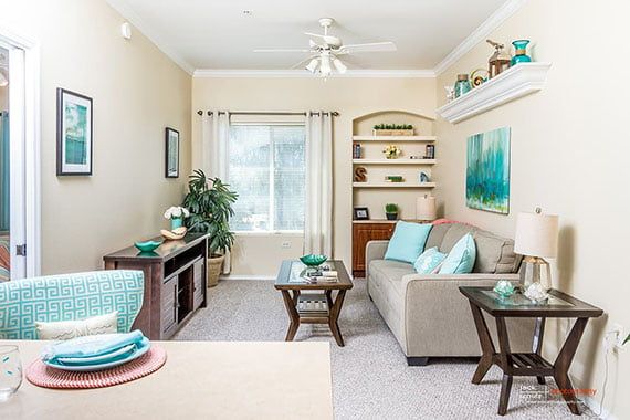 A modern living room with a cozy sofa, decorative pillows, and a stylish coffee table.