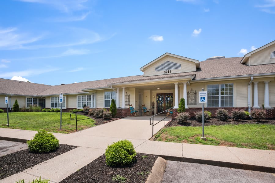 A well-maintained healthcare facility entrance with surrounding greenery and accessible pathways.