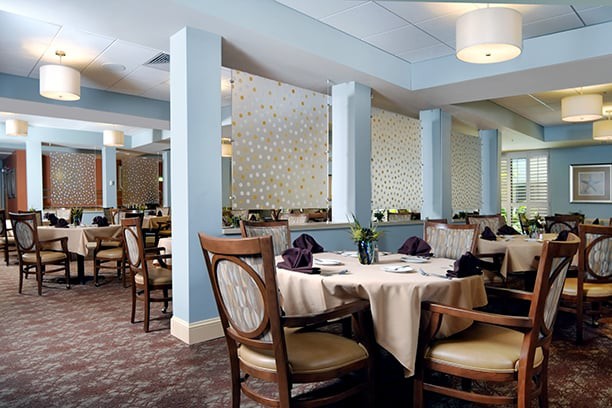 An elegant restaurant interior with neatly arranged tables and chairs.