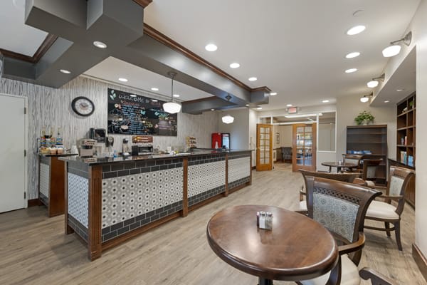 Cozy cafe interior with a modern coffee counter and seating area.