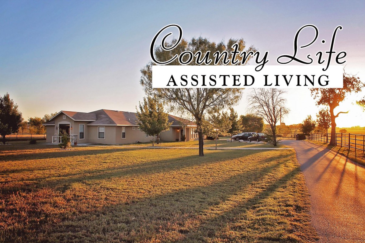Country Living Assisted Living facility surrounded by a scenic landscape at sunset.