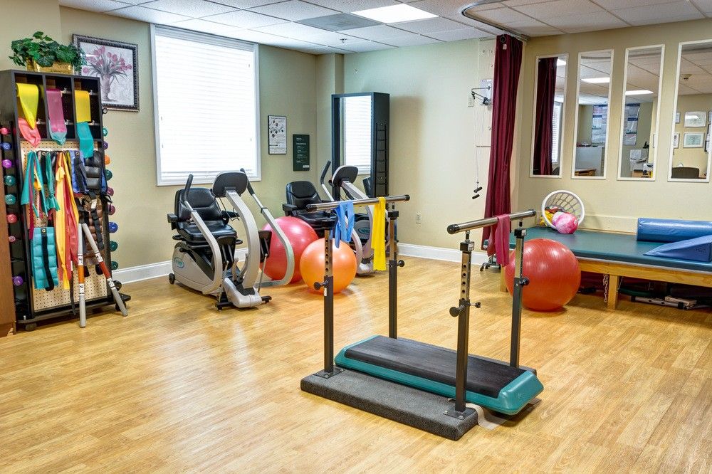 A rehabilitation exercise room equipped with various therapy tools and fitness machines.