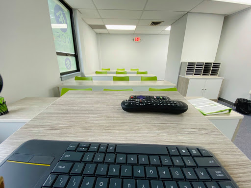 A modern office space featuring multiple desks and a keyboard with a mouse.