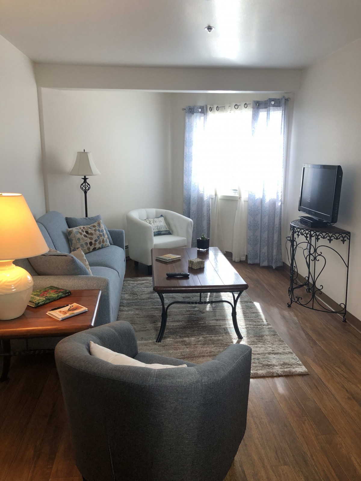 A cozy living room with comfortable seating and a TV.