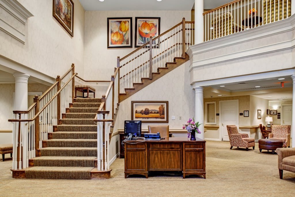 A welcoming lobby with a grand staircase and a reception desk.