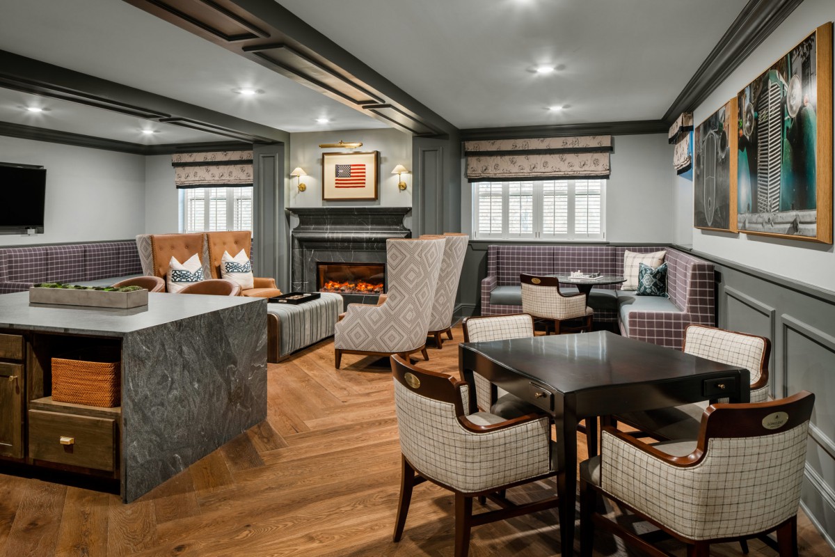 A cozy living room with elegant furniture, a fireplace, and wooden flooring.