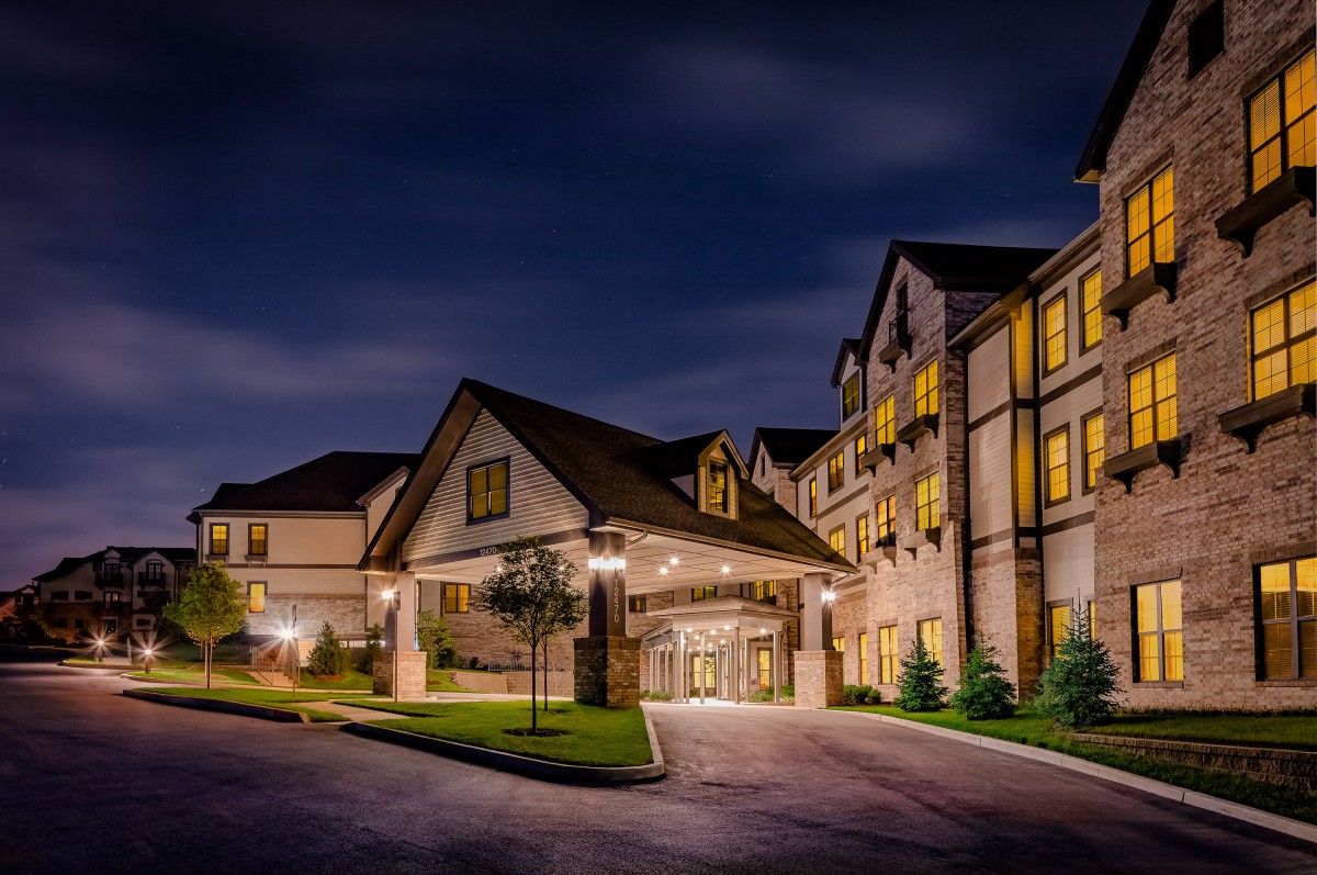 A well-lit hotel entrance at night.