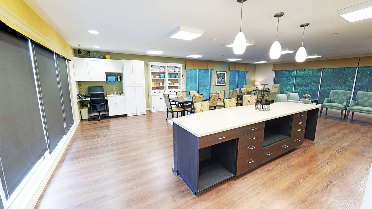 A spacious modern kitchen and dining area with an island counter and pendant lighting.
