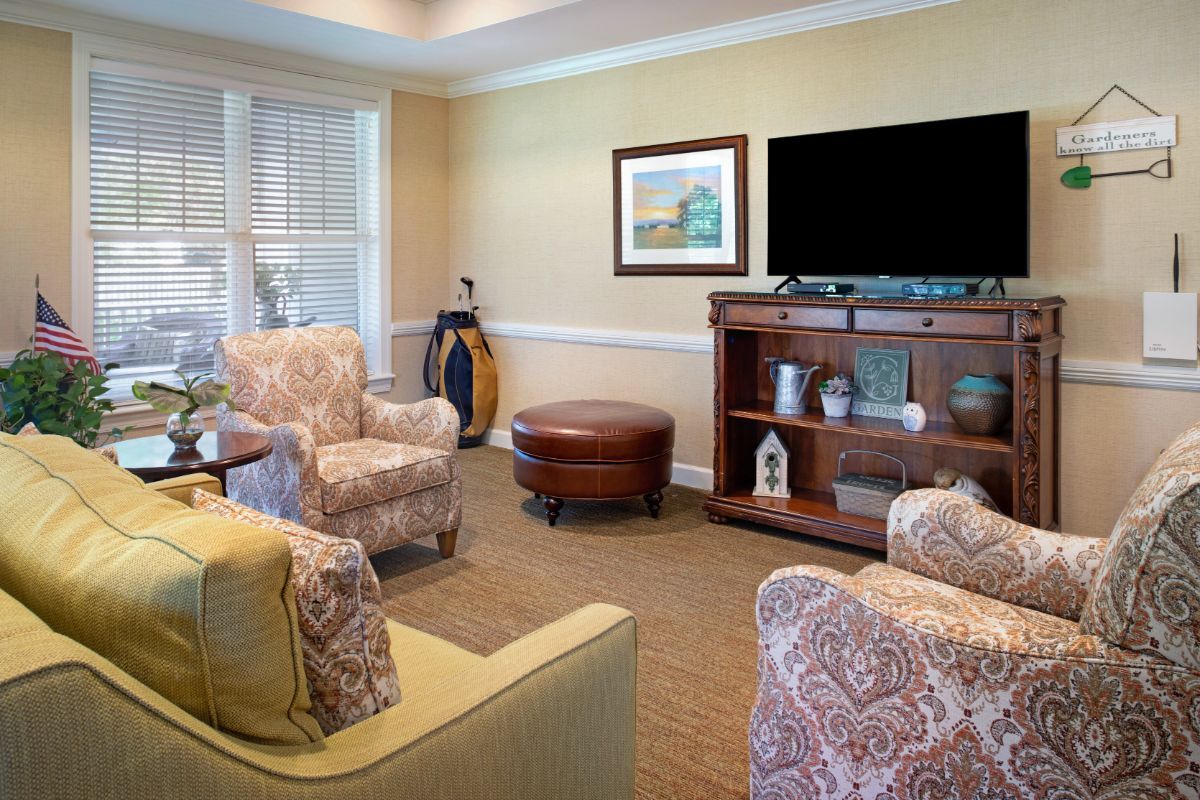 A cozy living room with comfortable seating, a television, and decorative elements.