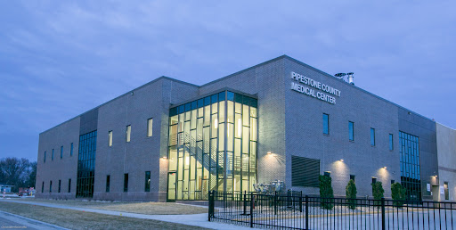 Proton Therapy Medical Center at dusk, showcasing modern architecture and well-lit entrance.