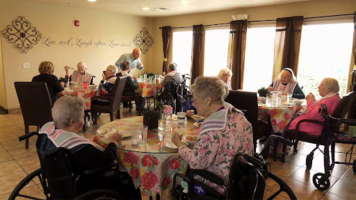 Residents enjoying a meal together in a communal dining area.
