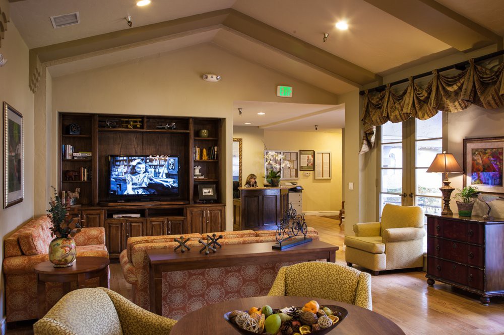 A cozy living room with comfortable seating, a television, and elegant decor.