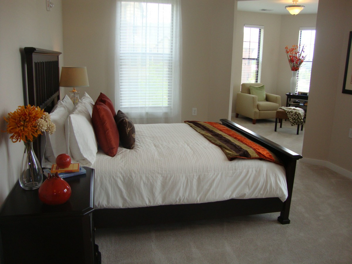 A modern bedroom with a neatly made bed and stylish decor.