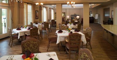 An elegant dining room setup with neatly arranged tables and chairs.
