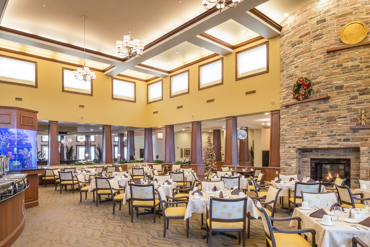 Spacious dining area with elegant table settings and warm lighting.