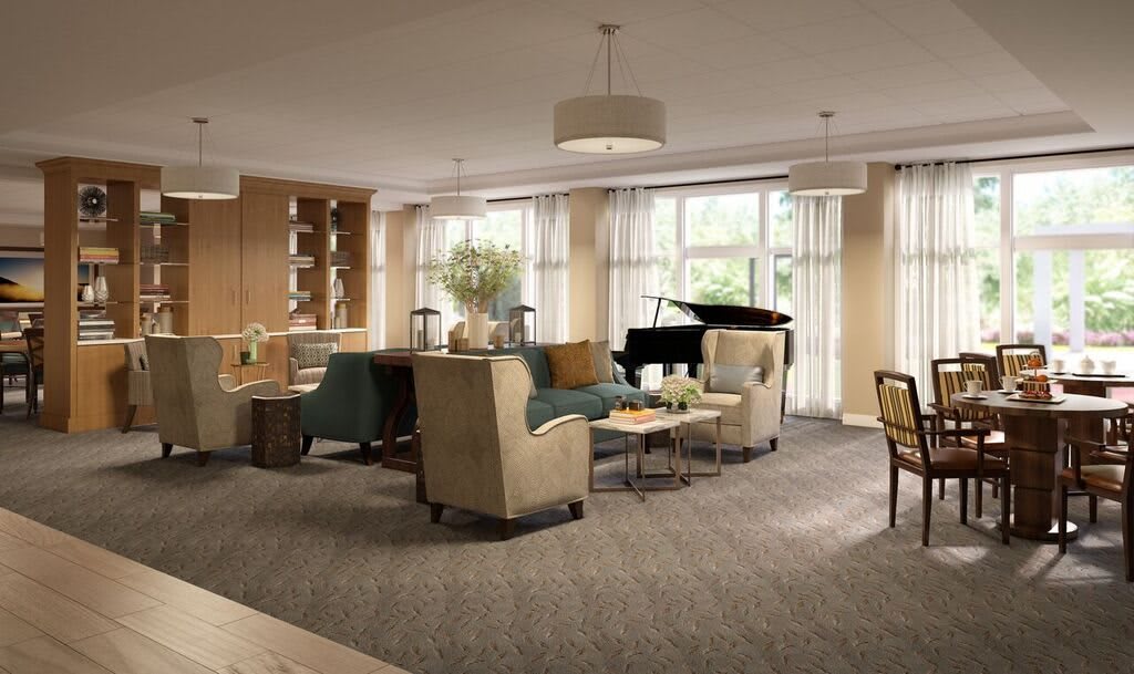 A beautifully decorated living room featuring a grand piano and comfortable seating area.