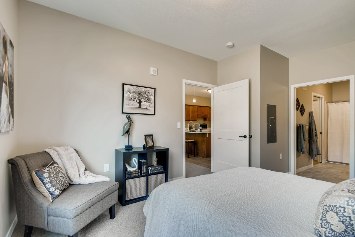 A modern, minimalist bedroom with sleek furnishings and neutral tones.