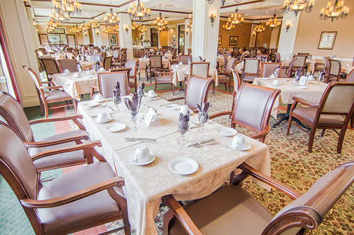 An elegant dining area featuring beautifully arranged tables and chairs, perfect for a sophisticated meal.