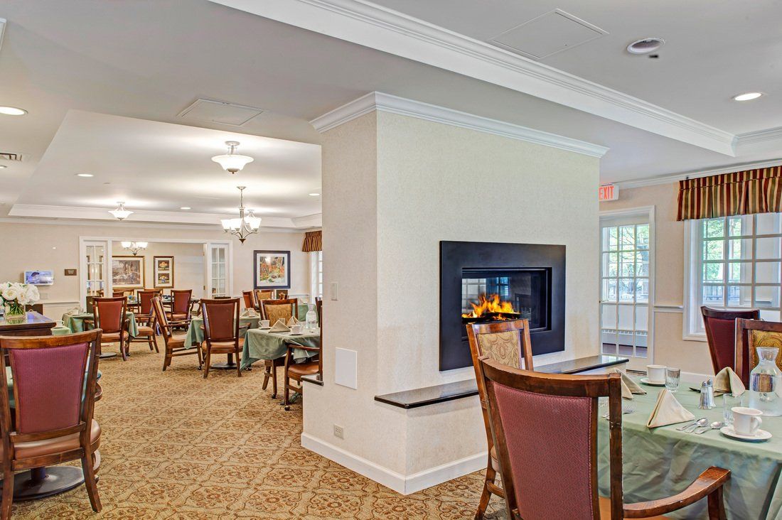 A cozy dining area featuring a central fireplace and elegant seating arrangement.