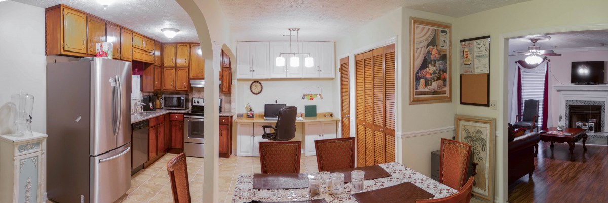 A cozy home office setup with a desk, computer, and comfortable chair.