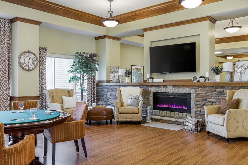 A cozy living room with a fireplace, television, and comfortable seating.