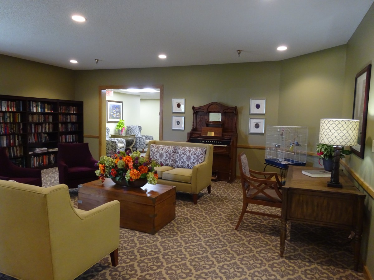 A cozy living room with comfortable seating, bookshelves, and elegant decor.