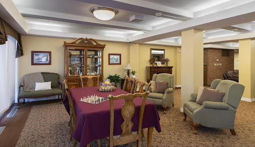 A cozy indoor dining area featuring a chess table and comfortable seating.